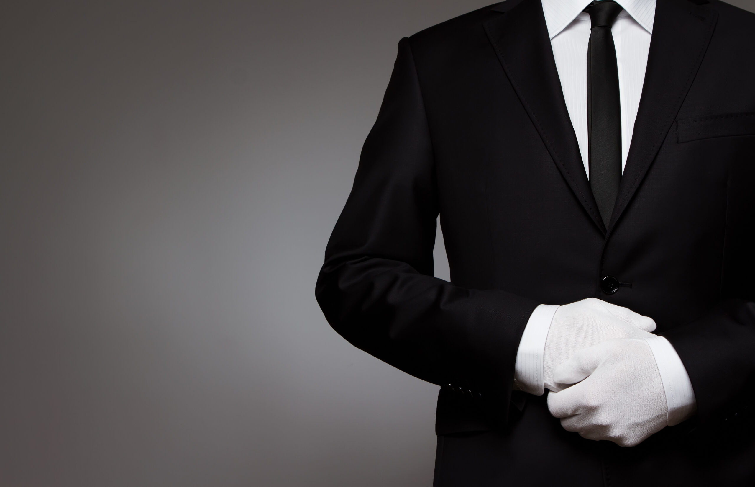 Butler in black tie and white gloves representing Beyond VIP white-glove concierge service
